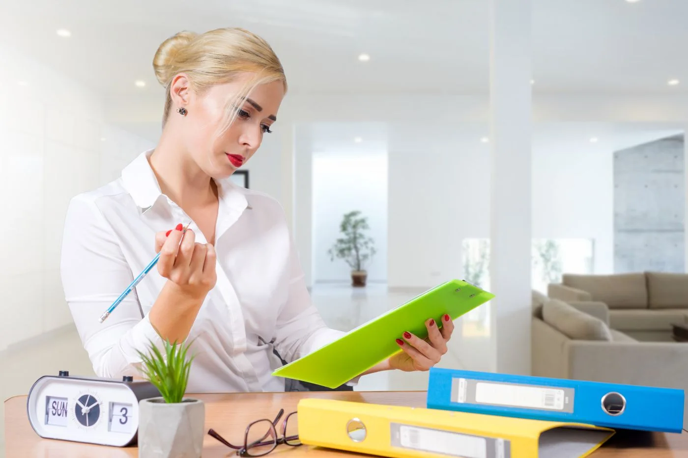 woman in office reviewing documents with focus and attention.