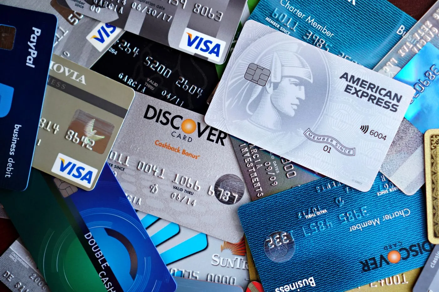 Close-up image of various credit cards including Visa, Mastercard, and American Express.