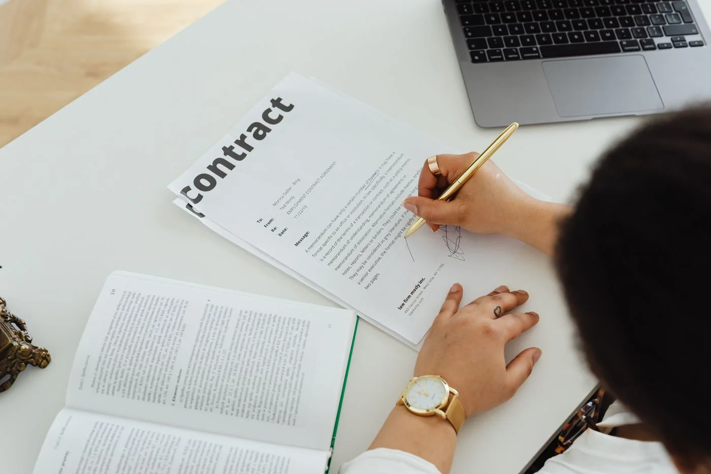 Image: Free Professional signing a business contract at a modern desk setup for office work.